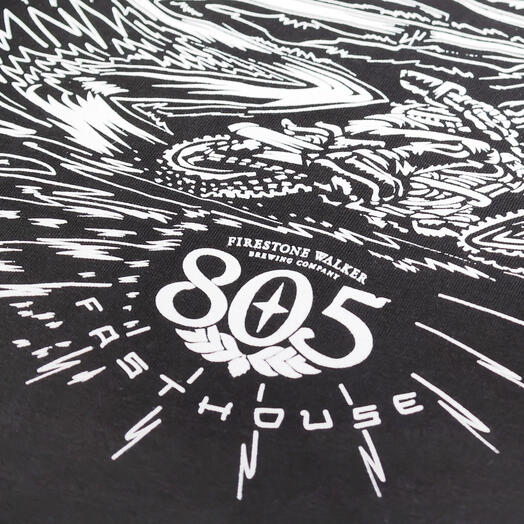 Close-up of 805 Desert Run Black Tee showing White woodcut-style graphic with radiating speed lines and winged emblem motif