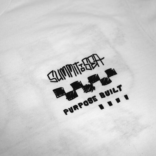 Close-up of 805 Purpose Black Tee showing Black print on white cotton showing angled text and geometric dash graphic detail