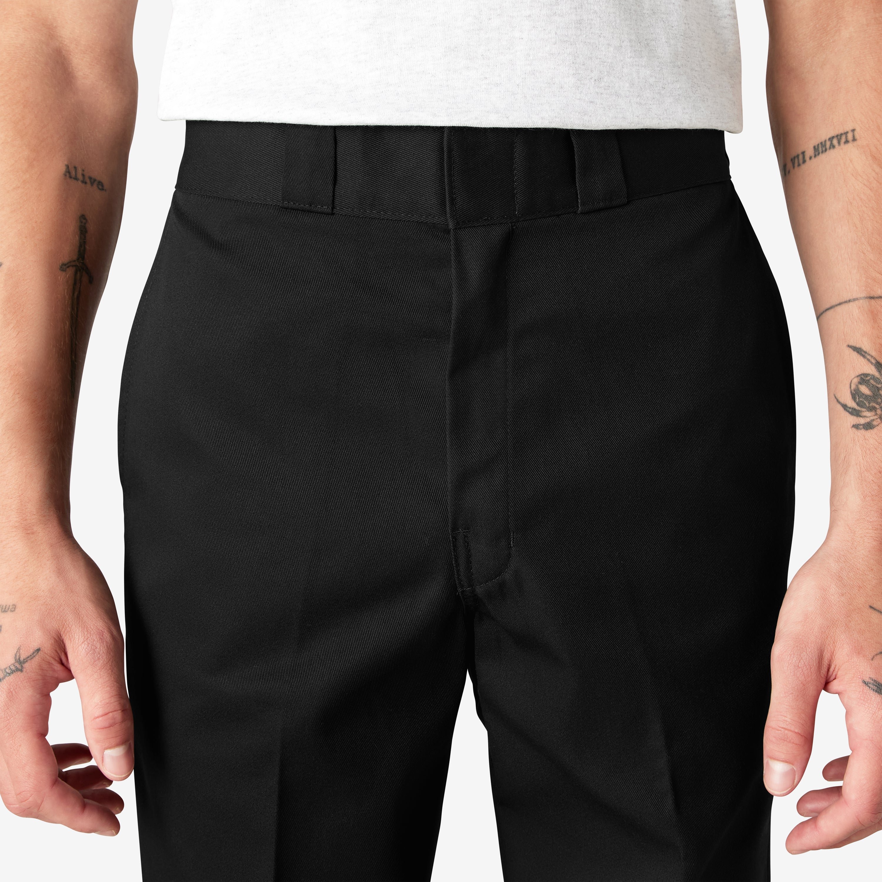 Person wearing 874 Original Work Pant Pants Black Pants, Wearer stands against neutral white backdrop, wearing black work