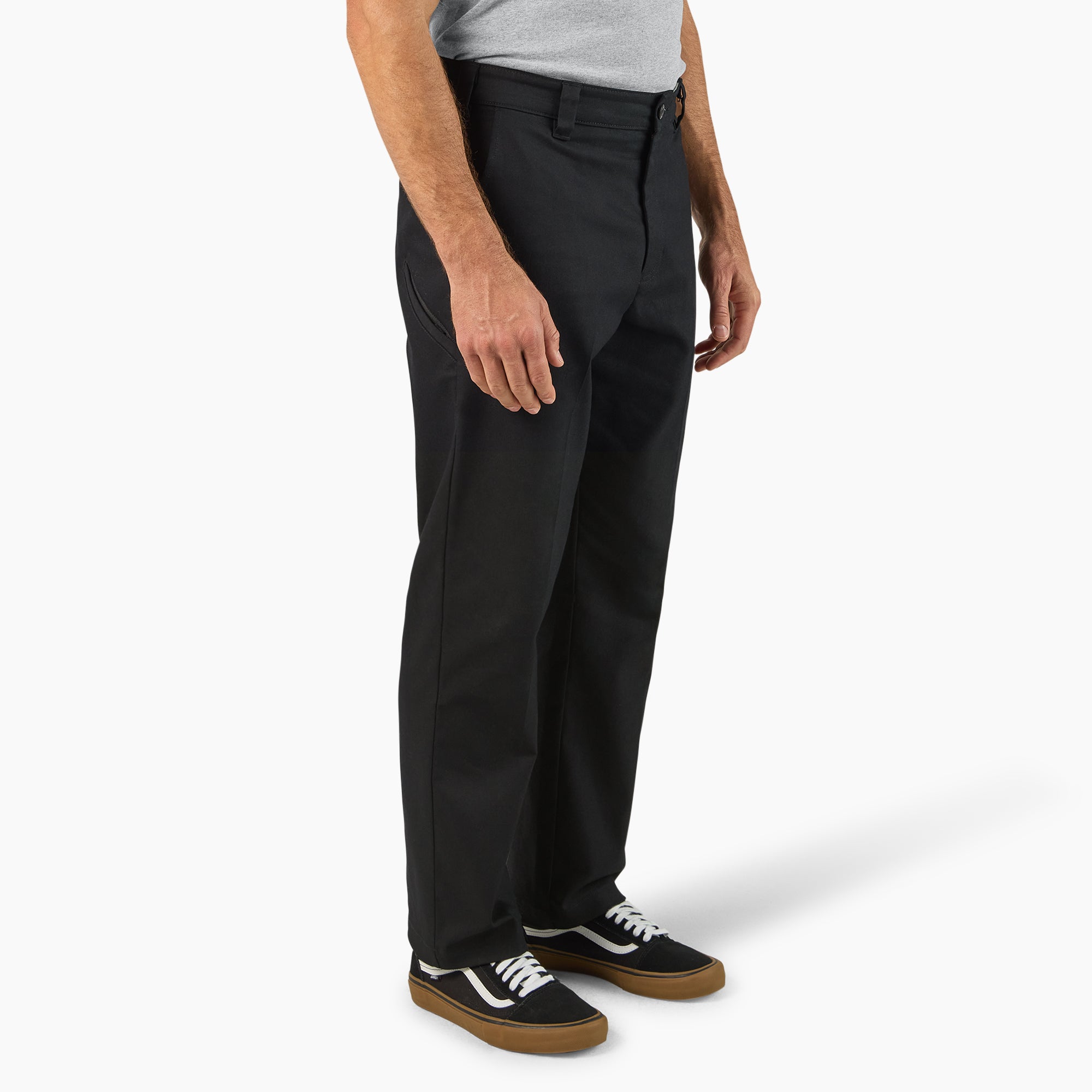 Person wearing 874 Pro Series Work Pant Pants Black Pants, Man standing against neutral white background wearing black work