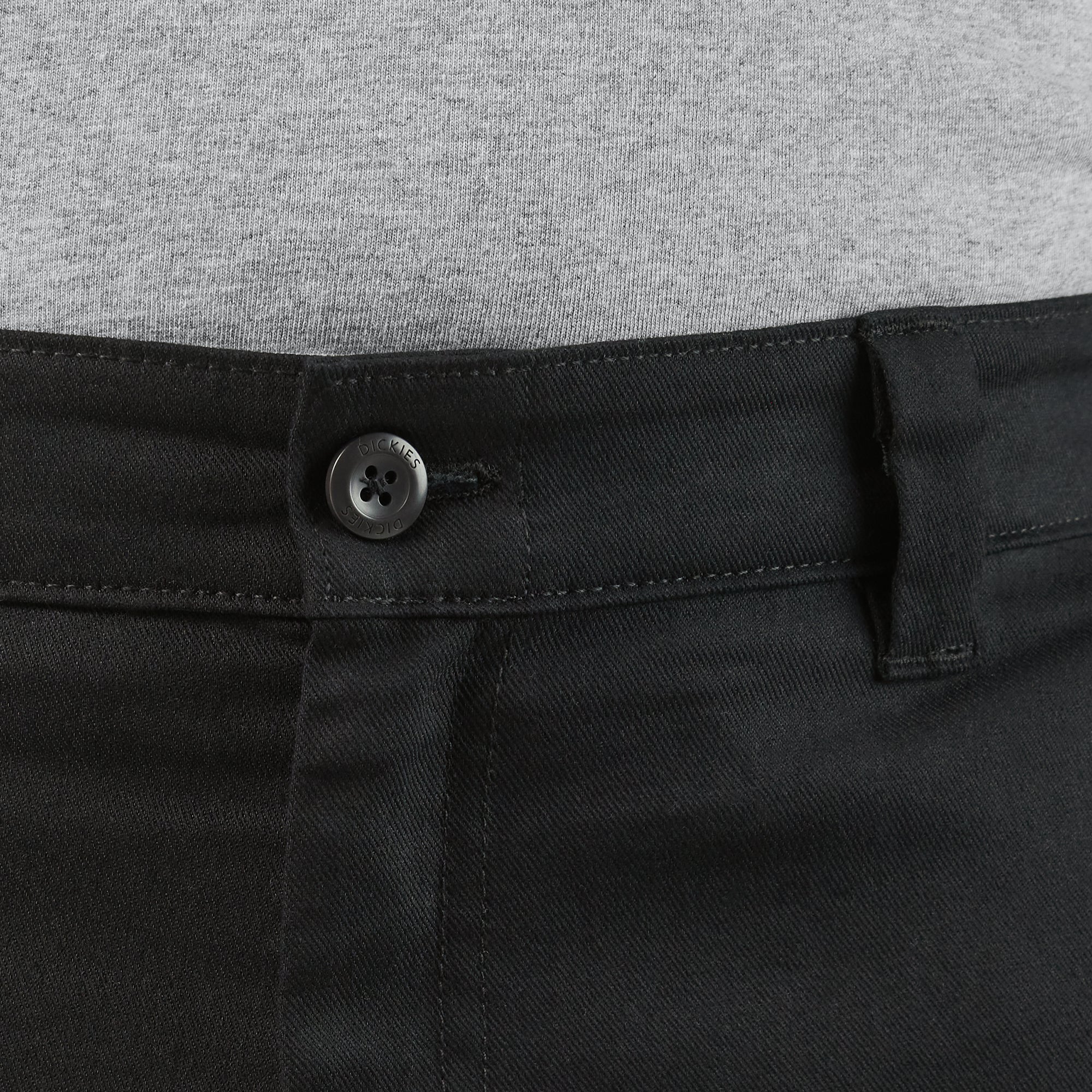 Close-up of 874 Pro Series Work Pant Pants Black Pants showing Metal button with four-hole design on black denim waistband -