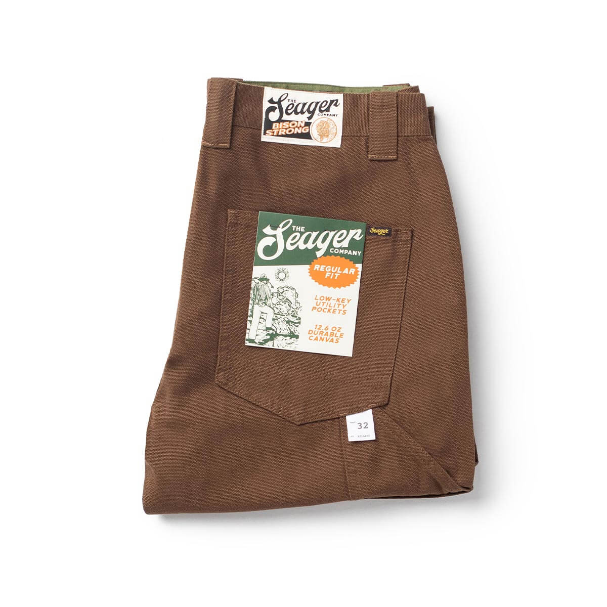 Close-up of Bison Canvas Pants Brown Pants showing Brown canvas with dual label tags, low-key utility pockets, durable weave