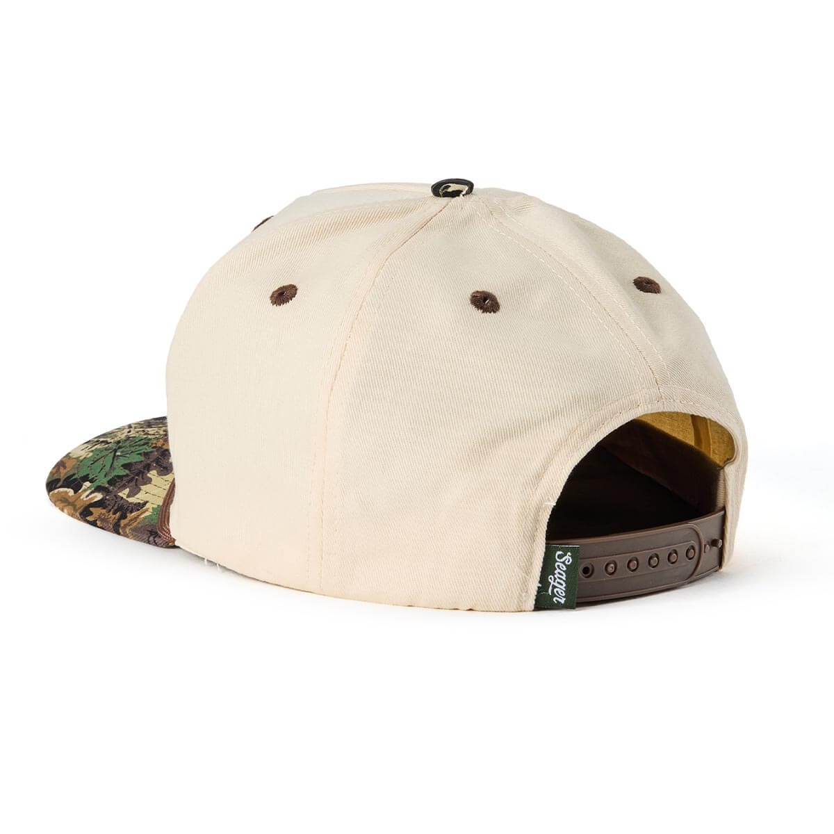 Close-up of Branded Snapback Hat Apparel Cream/Camo Apparel showing Cream cotton twill crown with brown embroidered eyelets,