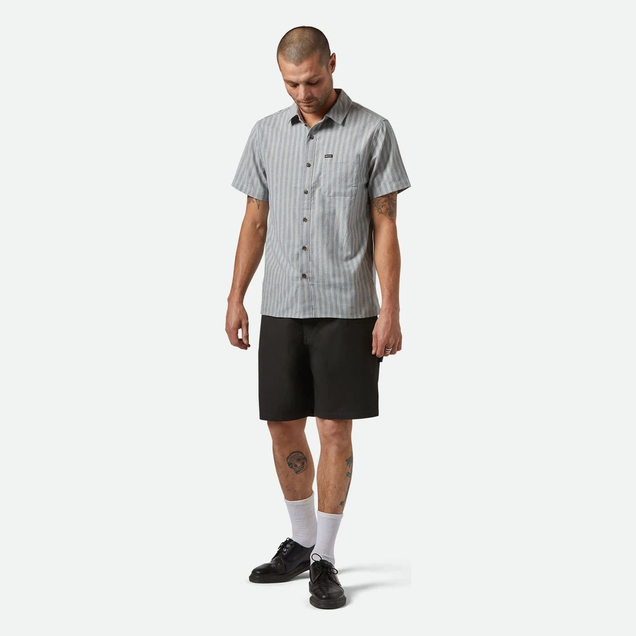 Person wearing Builders Carpenter Baggy Short Shorts Washed Black Shorts, Neutral studio setting with white background,