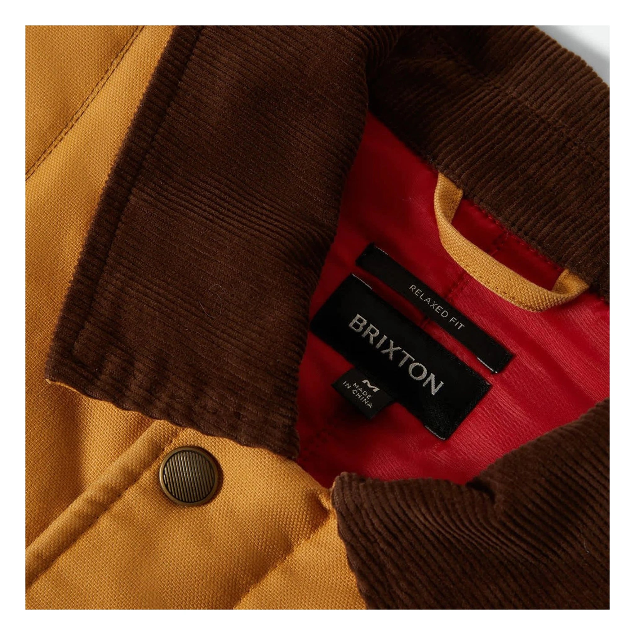 Care label on Builders Ranch Jacket Spruce Yellow Jacket showing Black woven label reading "BRIXTON" with "RELAXED FIT" text
