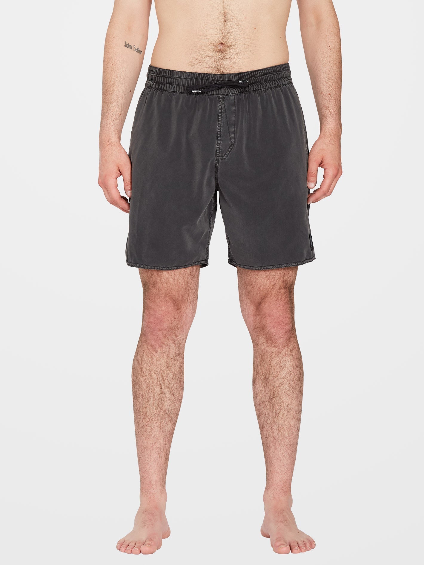 Person wearing Center Trunk 17" Boardshorts Black Boardshorts, Man standing shirtless against neutral white background -
