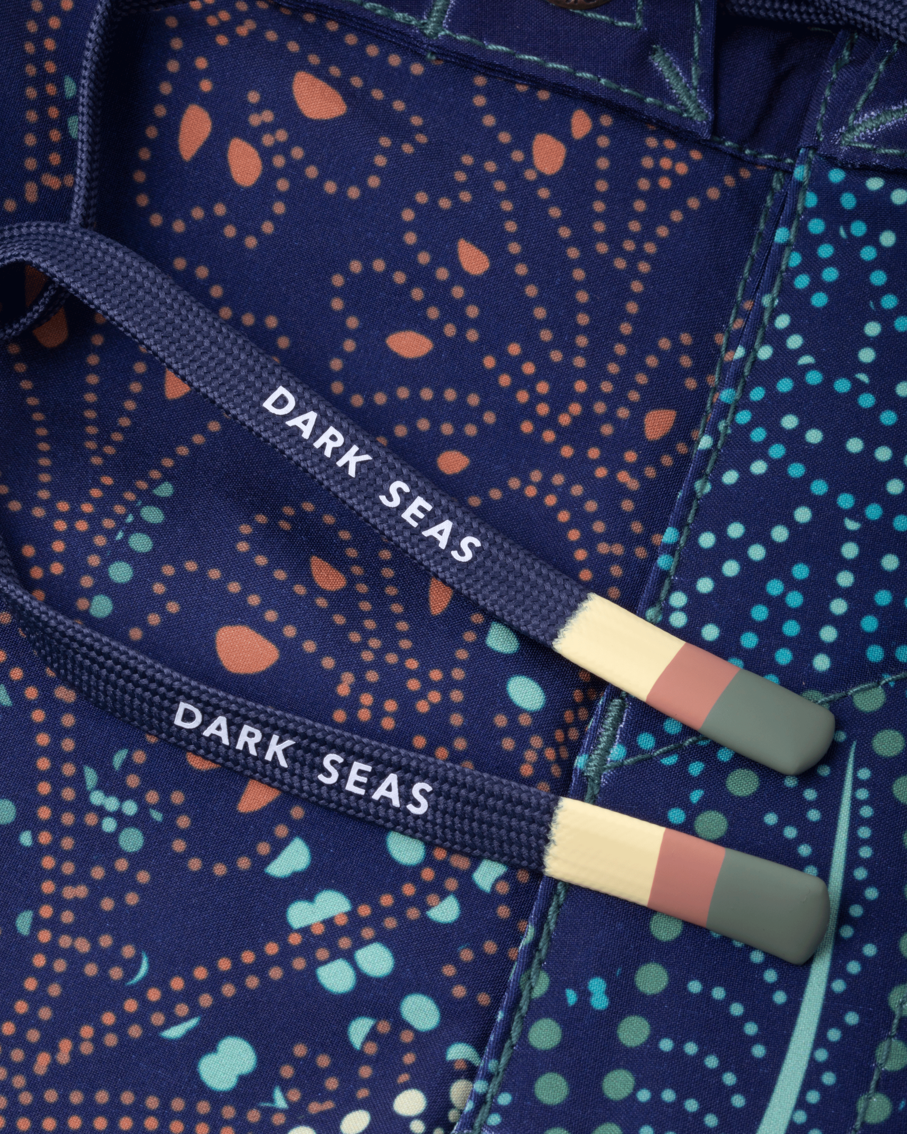 Care label on Deepwater Boardshort Boardshorts Navy Boardshorts showing White text reading "DARK SEAS" on navy webbing with