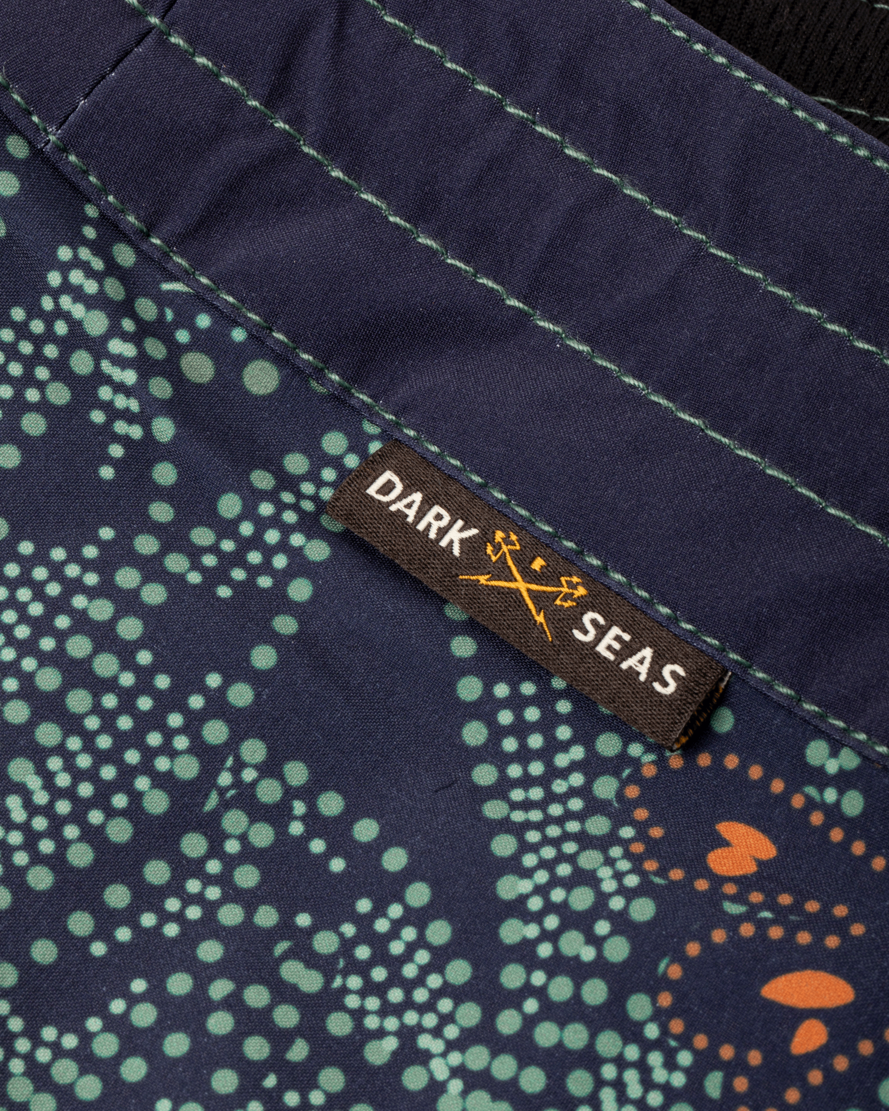 Care label on Deepwater Boardshort Boardshorts Navy Boardshorts showing Brown woven label with white and gold text and