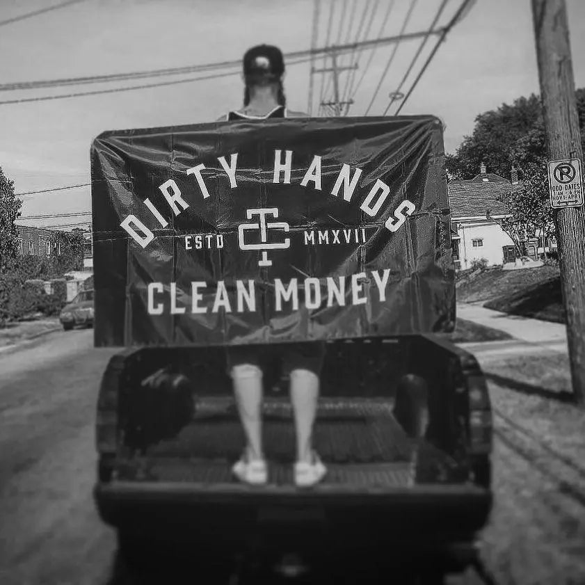 Back of DHCM Double Sided Flag Accessory Accessory, Black flag with white text reading "Dirty Hands" and "Clean Money" with