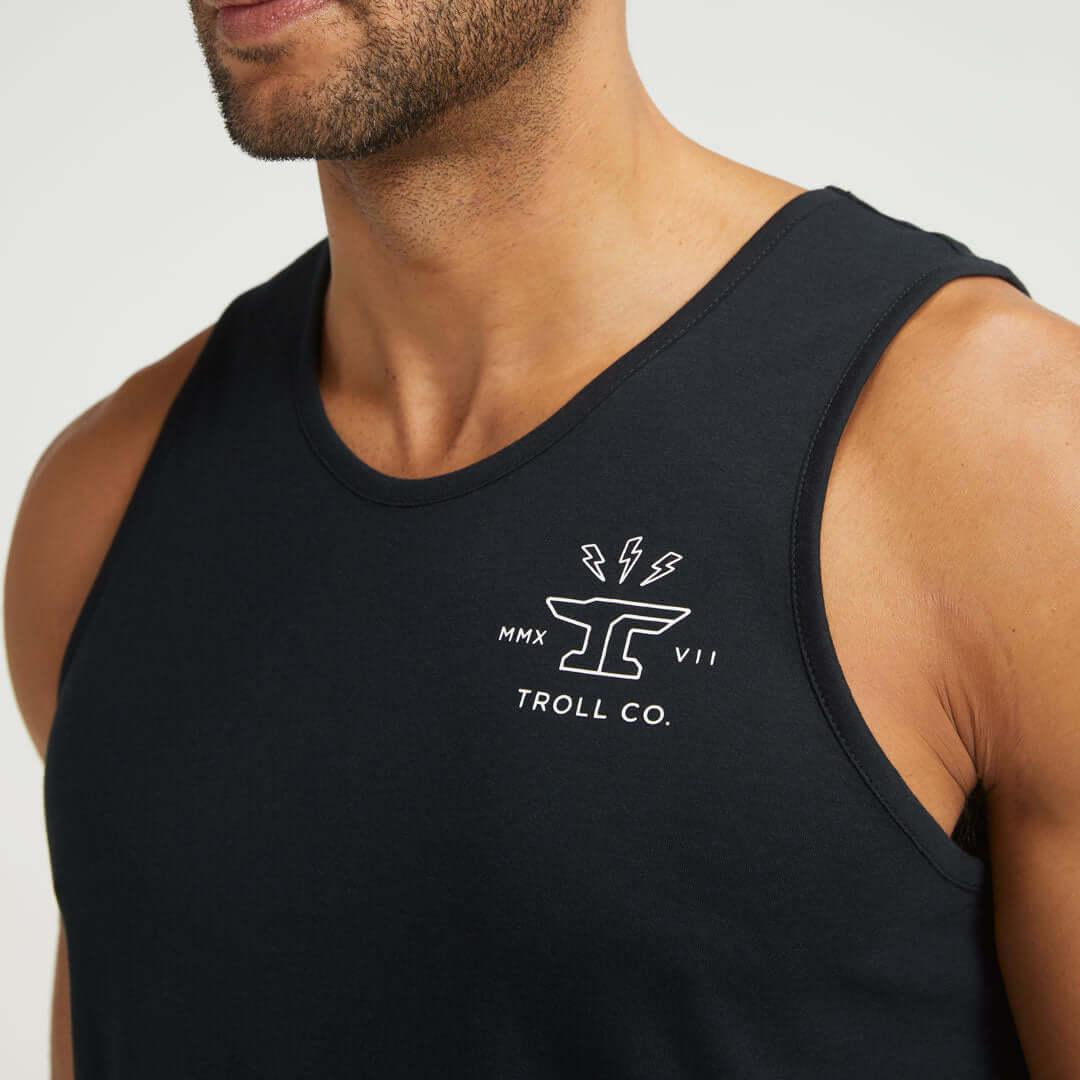 Person wearing DHCM Twisting Wrenches Tank Tank Top Black Tank Top, Man wearing black tank top against neutral studio