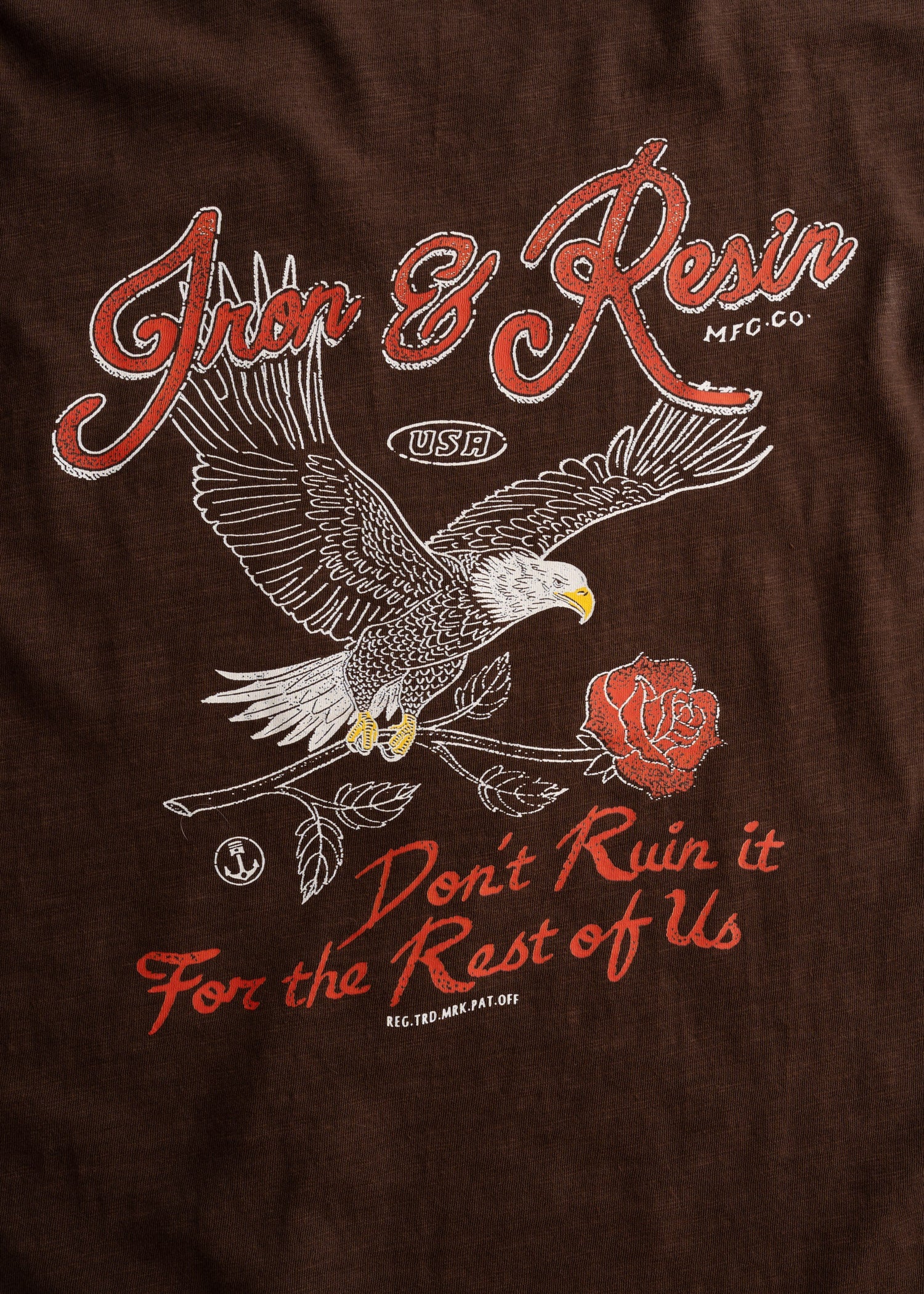 Close-up of Don't Ruin It Brown Tee showing Embroidered eagle with white and gold detailing on brown fabric - Slowride Supply