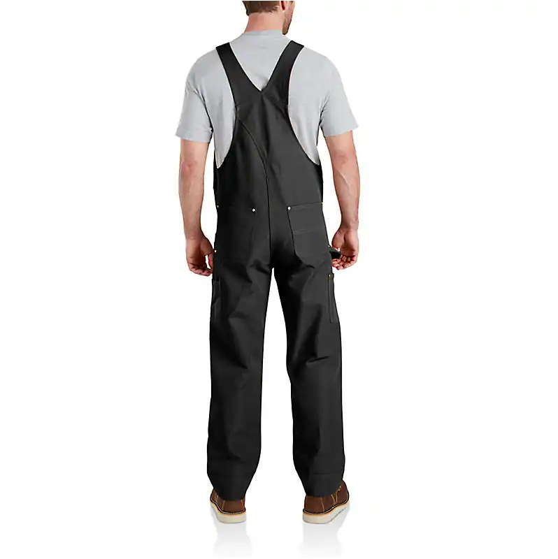 Person wearing Duck Bib Overalls Black Overalls, Wearer standing against neutral white studio backdrop - Slowride Supply