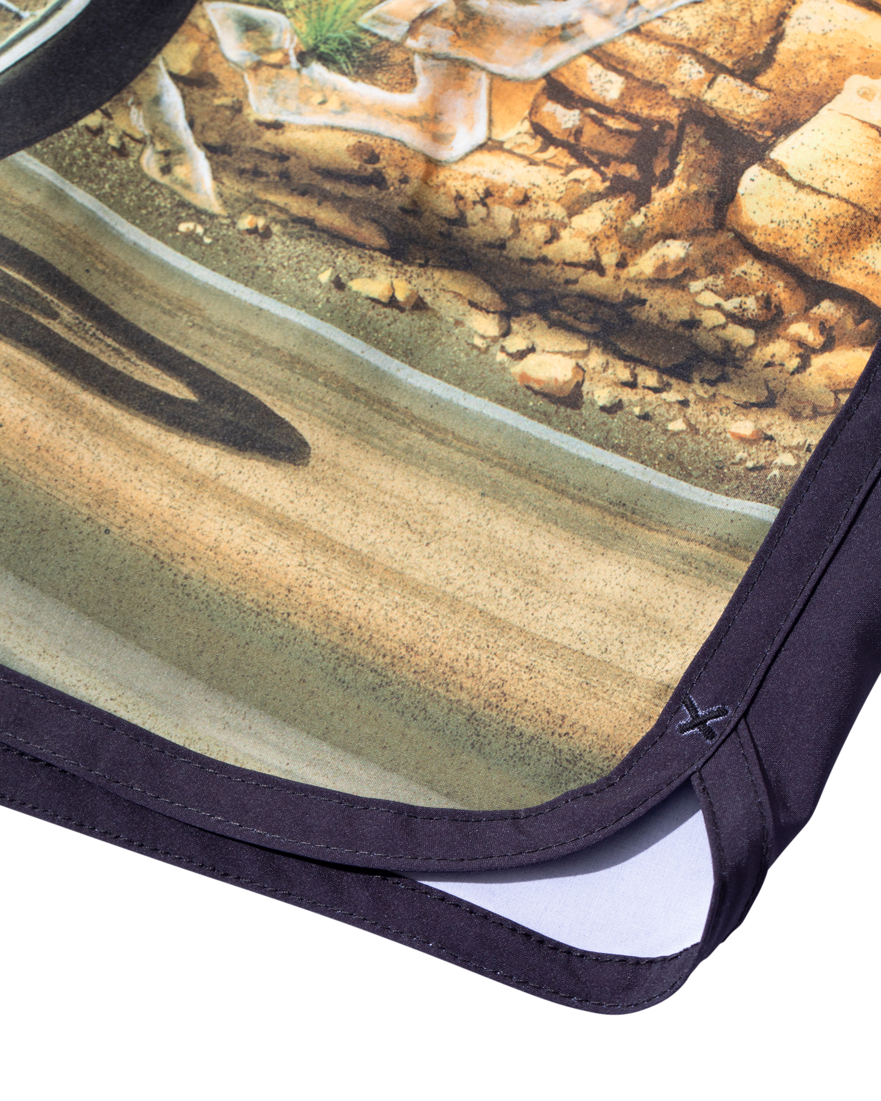 Close-up of Ghost Rider Boardshort Boardshorts Black Boardshorts showing Black binding and hem stitching with printed dirt