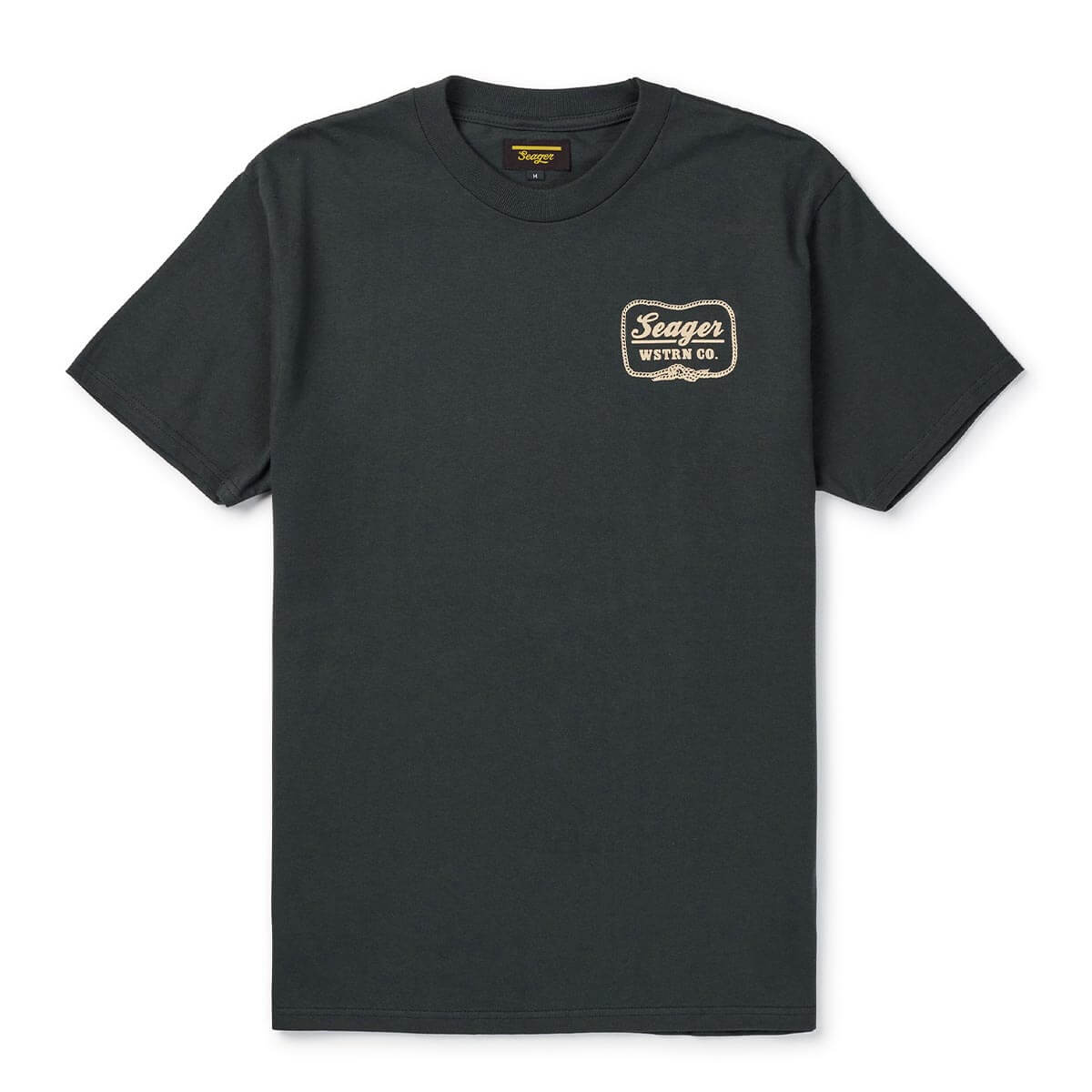Close-up of High Noon Vintage Black Tee showing Charcoal tee with small cream and gold decorative badge logo on chest