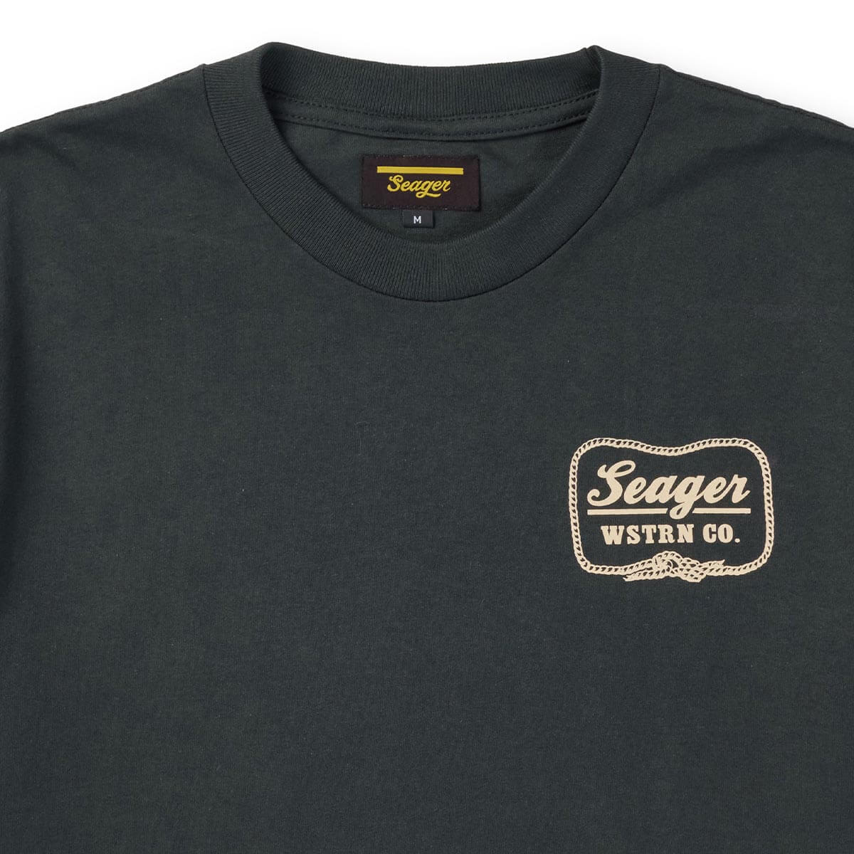 Close-up of High Noon Vintage Black Tee showing Crew neck tee with cream chest print featuring rope border and knot detail -
