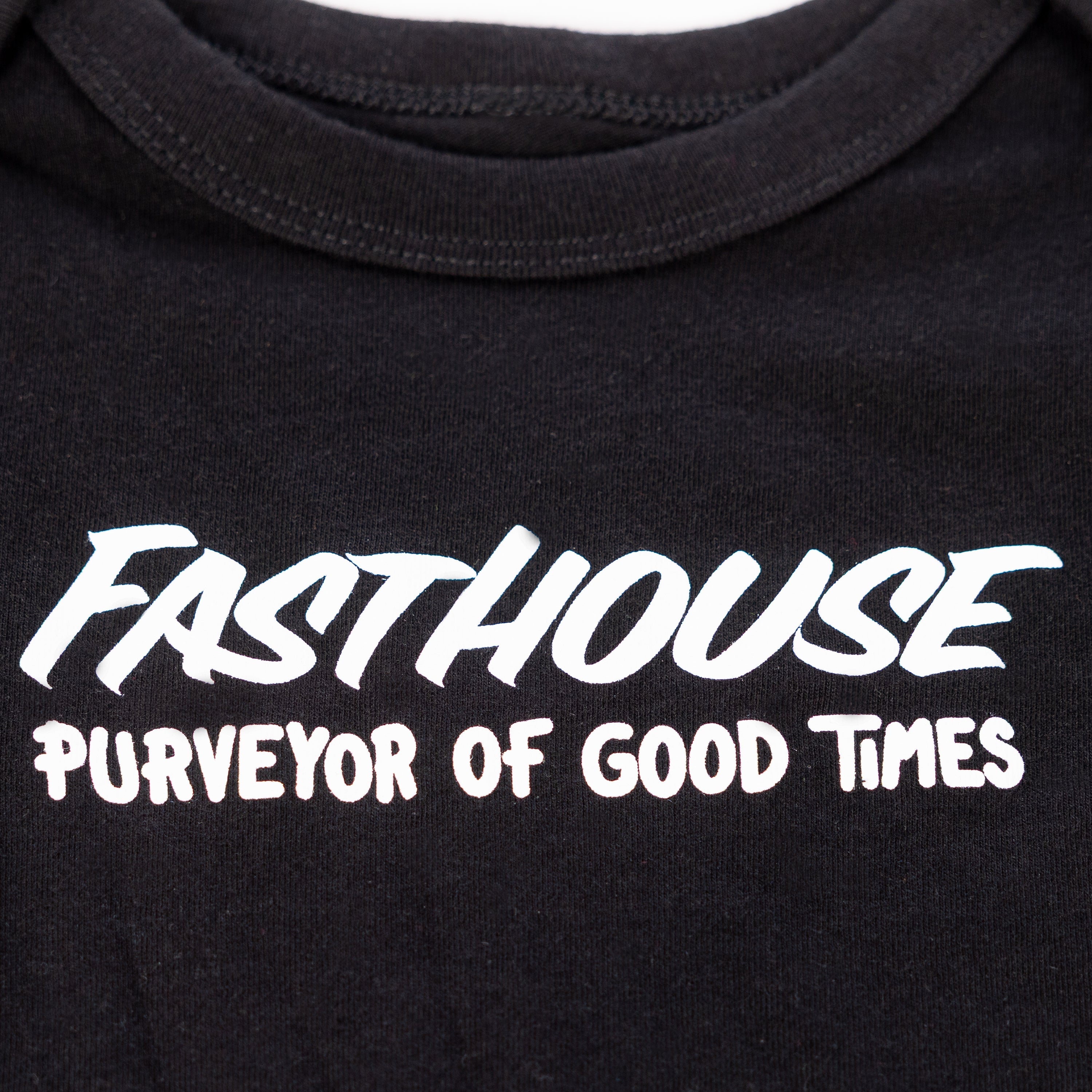 Back of Infant Sprout Onesie Black Onesie, Black with white italic "Fasthouse" text and white "Purveyor of Good Times"