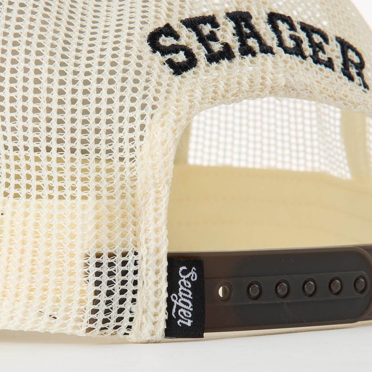 Close-up of Keep It Country Trucker Apparel Brown/Cream Apparel showing Cream mesh fabric with black embroidered text and