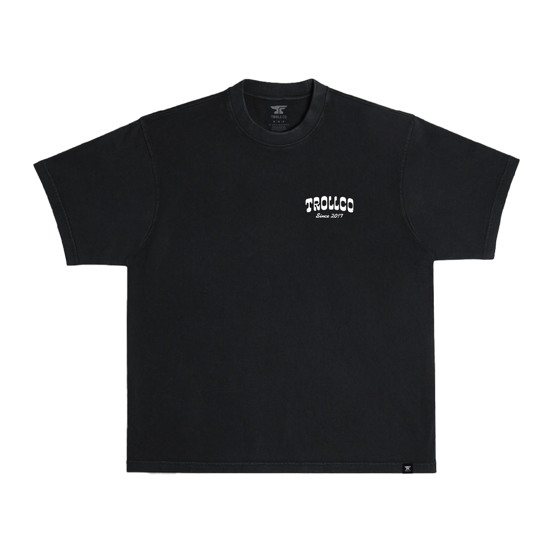 Close-up of Money Shot Heavyweight Tee showing Black heavyweight cotton with small white chest print and script text reading