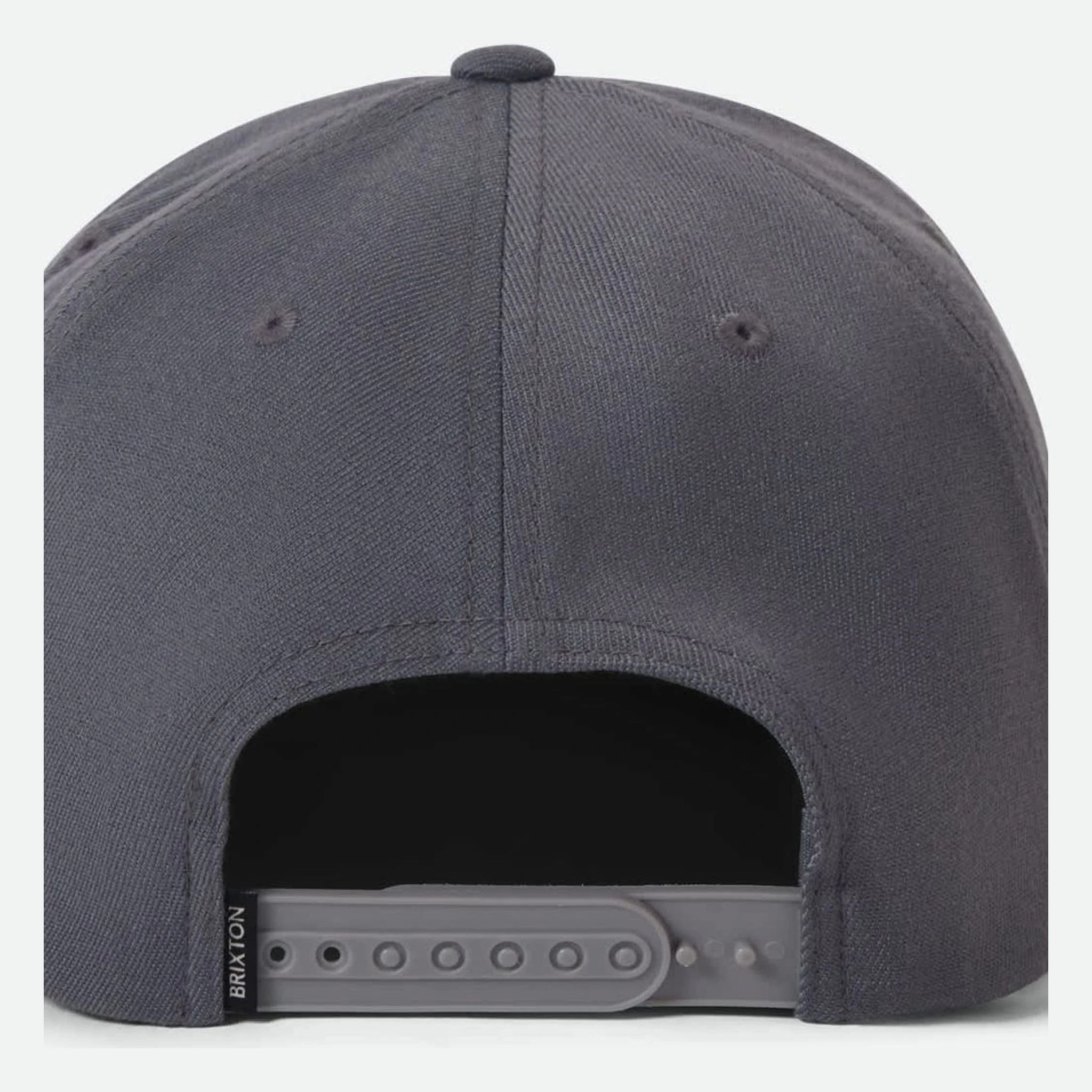 Close-up of Oath III Snapback Khaki/primal Green Hat showing Charcoal gray snapback with gray plastic snap closure and black