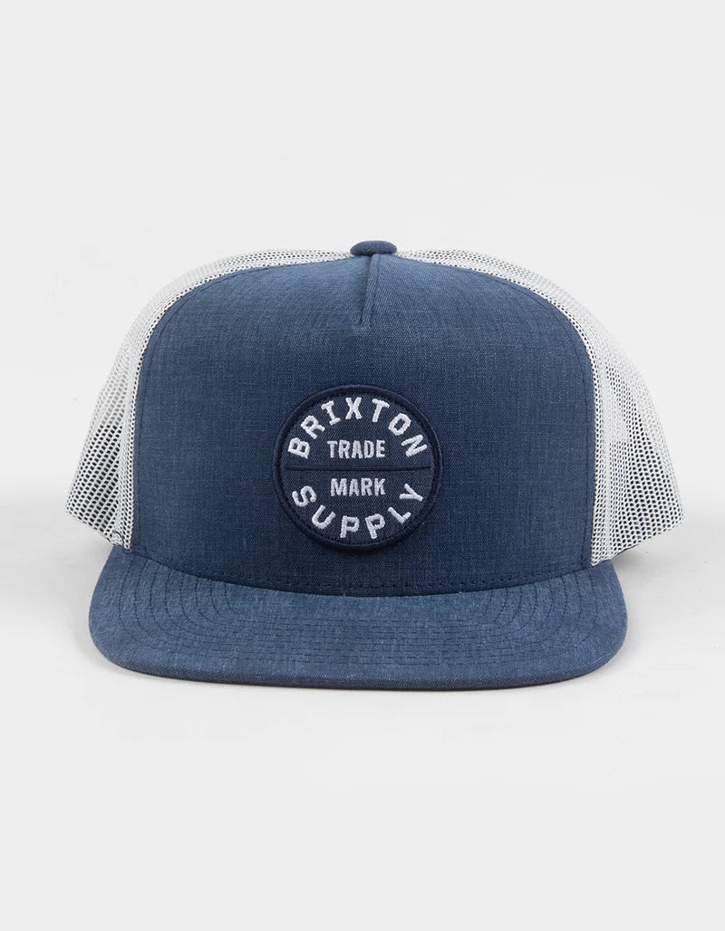 Oath MP Trucker Hat Apparel front view, Blue chambray front and bill with white mesh trucker panels, circular embroidered