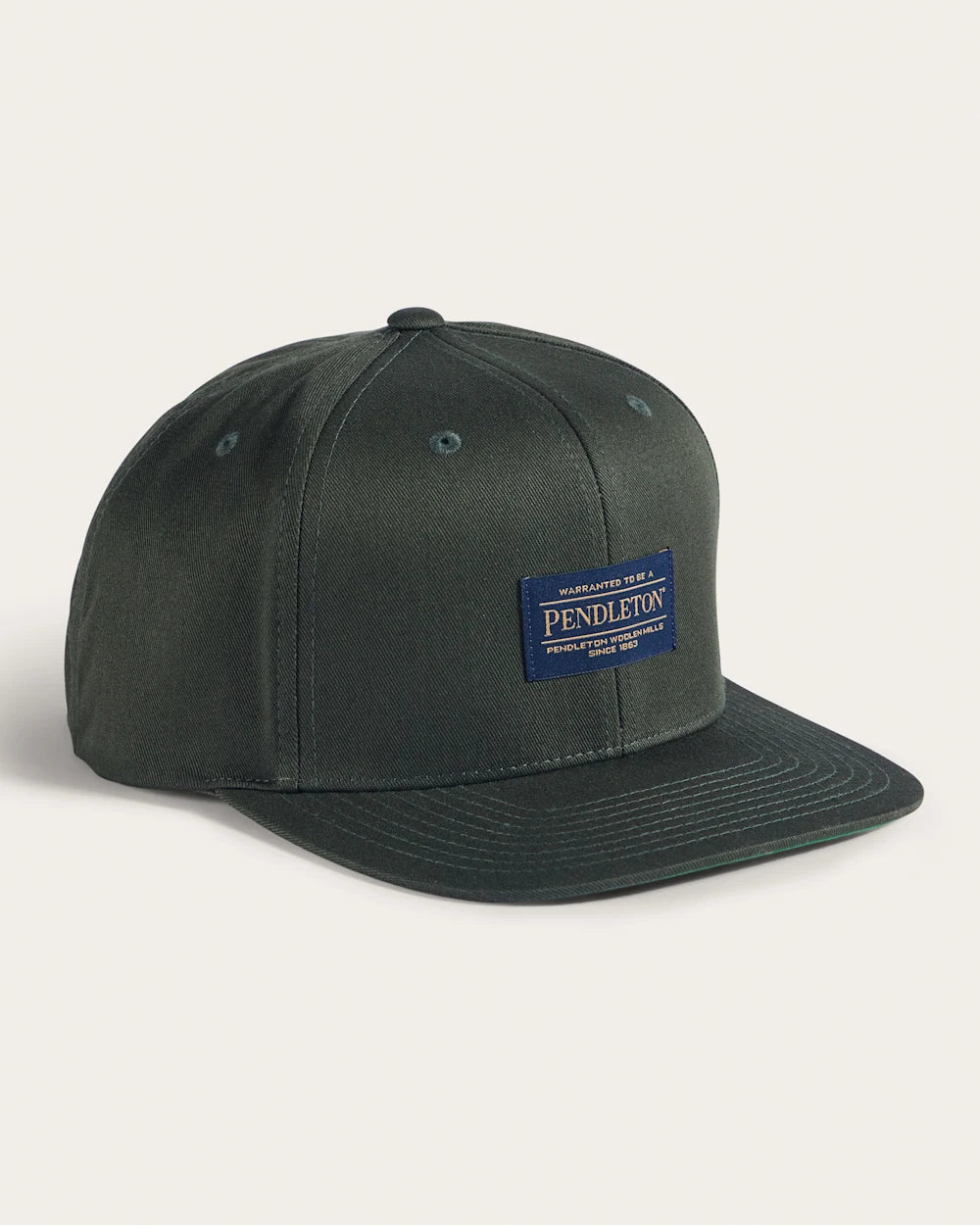 Logo Flat-brim front view, Charcoal grey with navy woven label patch featuring gold text and "since 1863, Black Hat -