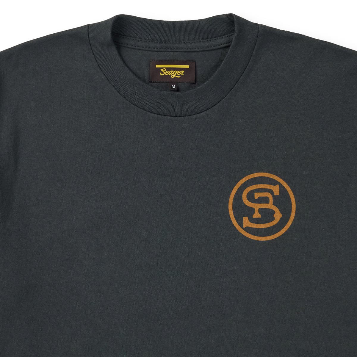 Close-up of Ride for the Brand Vintage Black Tee showing Crew neck collar with ribbed trim and woven label showing gold