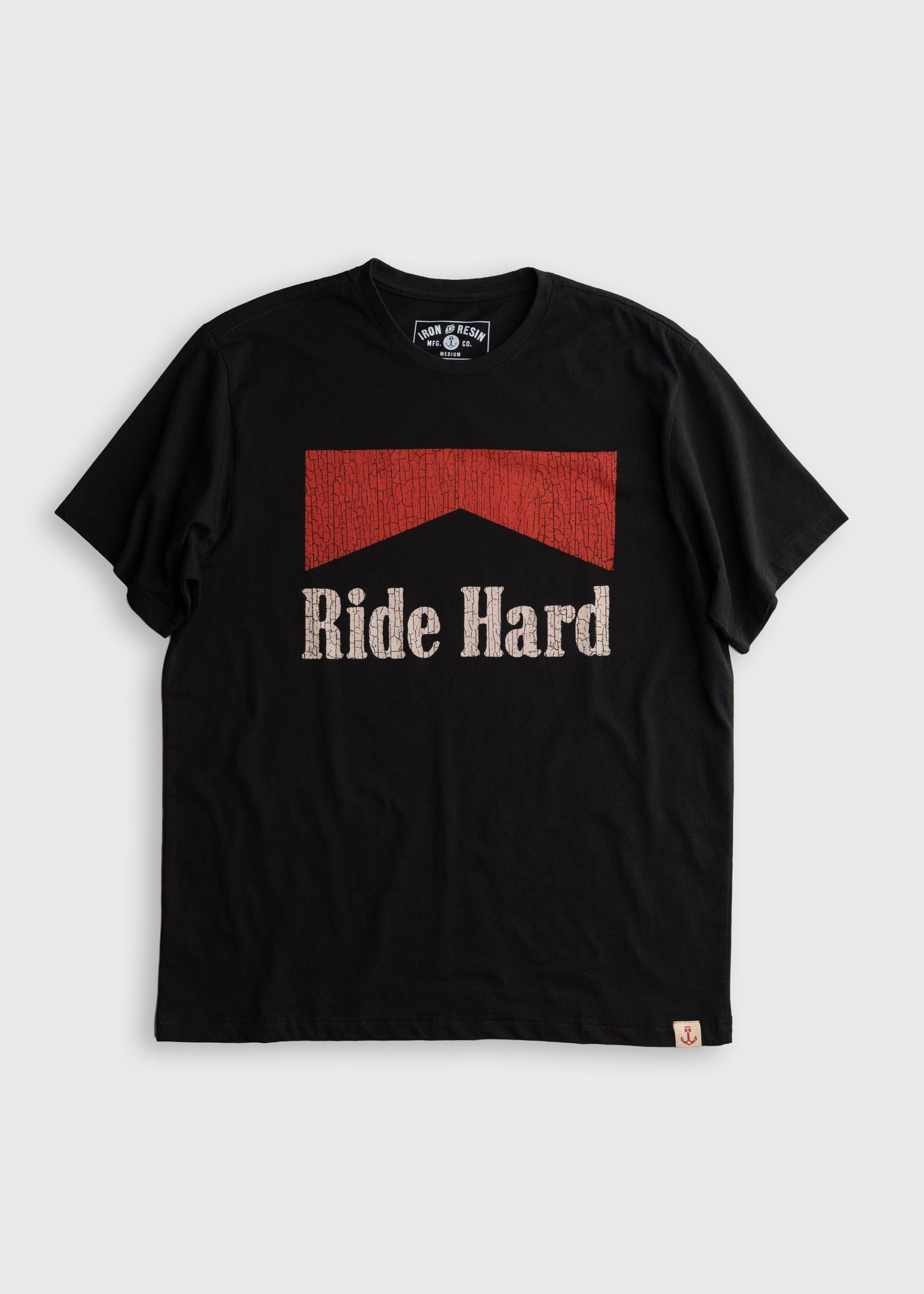 Ride Hard front view, Black with red cracked texture panel and cream distressed "Ride Hard" type below chevron graphic,