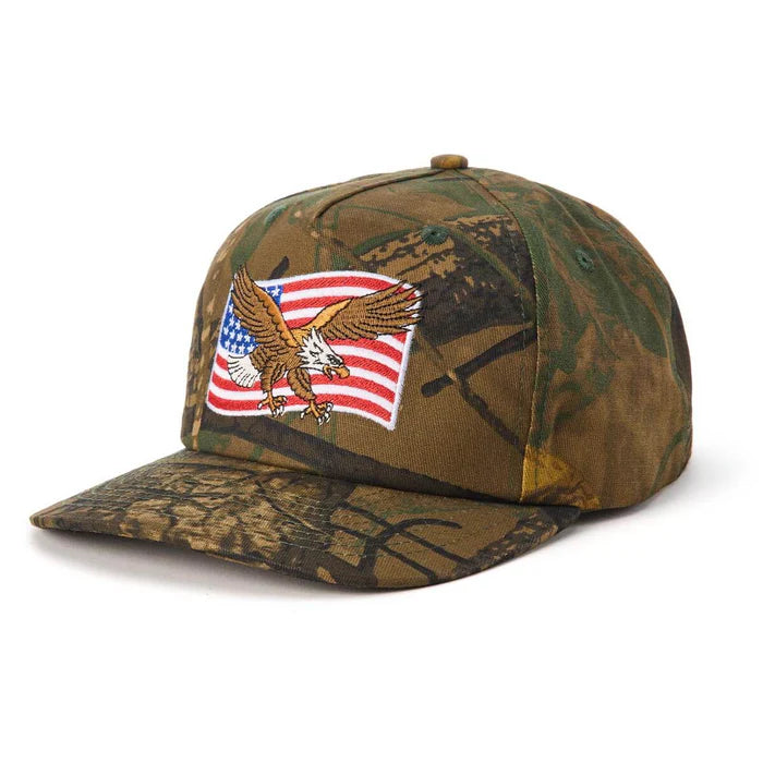 Close-up of SGR USA Snapback Camo Hat showing Olive and brown camouflage with embroidered eagle and American flag graphic on