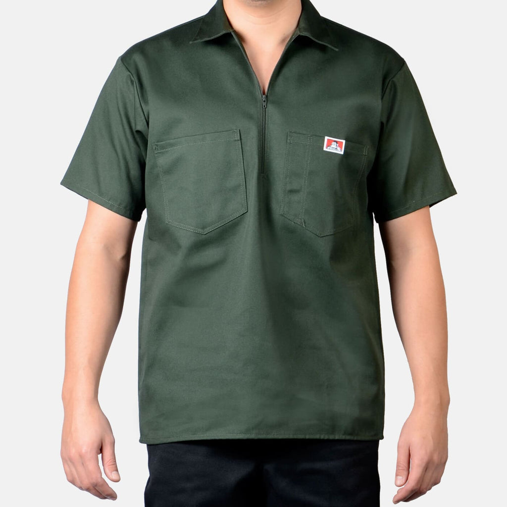 Person wearing Short Sleeve Solid Half Zip S/S Woven Black S/S Woven, Man wearing olive green short-sleeve work shirt