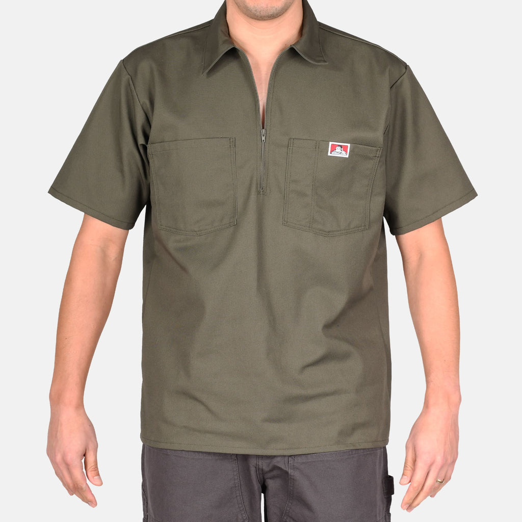 Person wearing Short Sleeve Solid Half Zip S/S Woven Black S/S Woven, Man wearing olive work shirt with two chest pockets