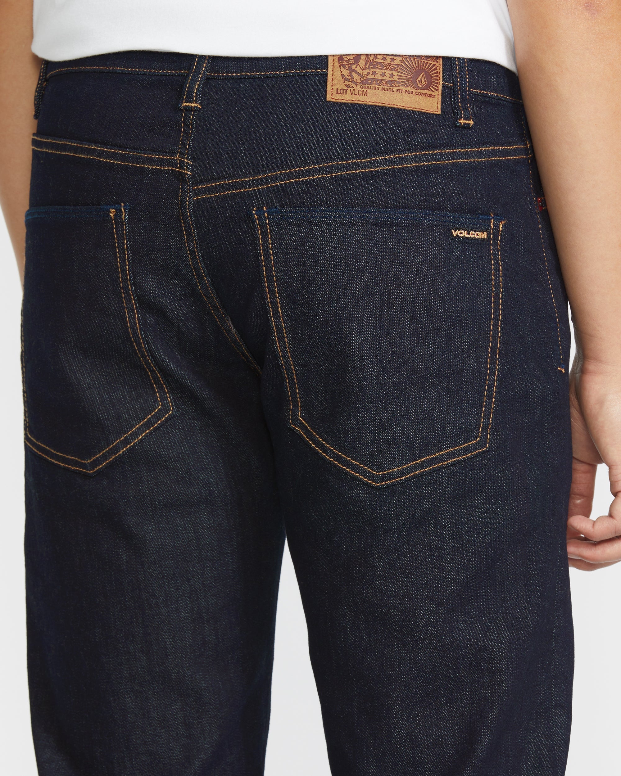 Person wearing Solver Denim Pants Vintage Blue Pants, Worn casually with a white t-shirt, showing the back pocket and
