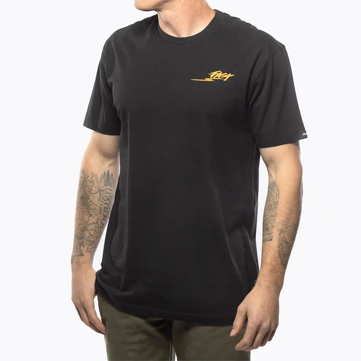 Person wearing Tomahawk Natural Tee, Man wearing black tee against white studio background - Slowride Supply