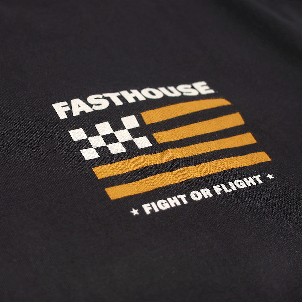 Close-up of Unite Embroidered graphic with white "FASTHOUSE" text, checkered flag pattern, gold horizontal stripes, and