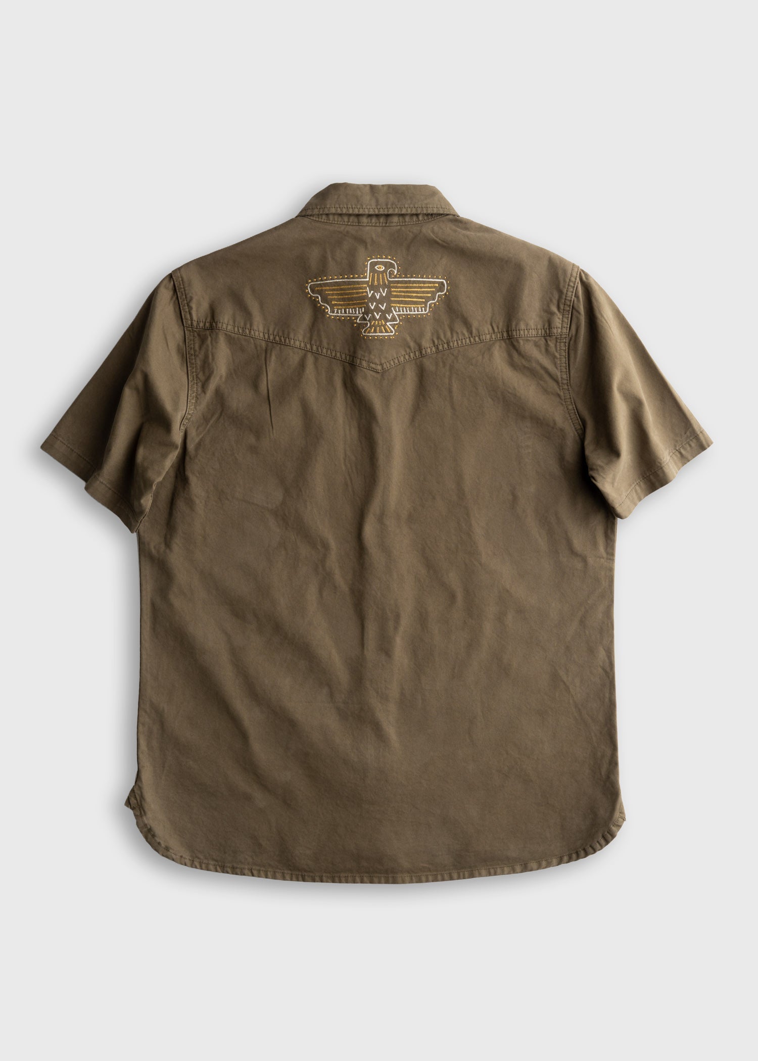 Back of Westy Shirt S/S Woven Light Khaki S/S Woven, Light khaki with cream outline eagle graphic centered on back yoke -