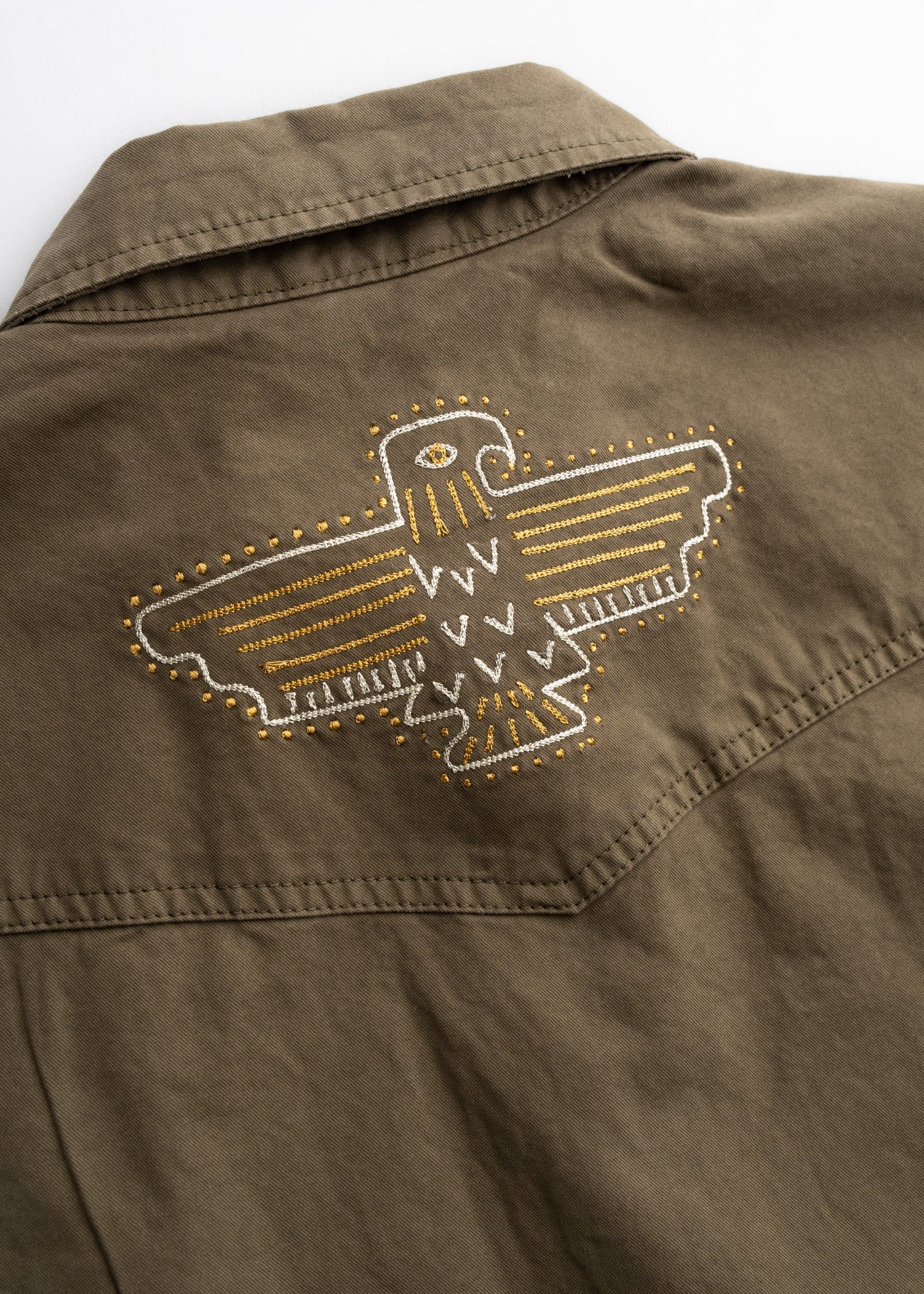 Close-up of Westy Shirt S/S Woven Light Khaki S/S Woven showing Embroidered eagle graphic with gold and white stitching on