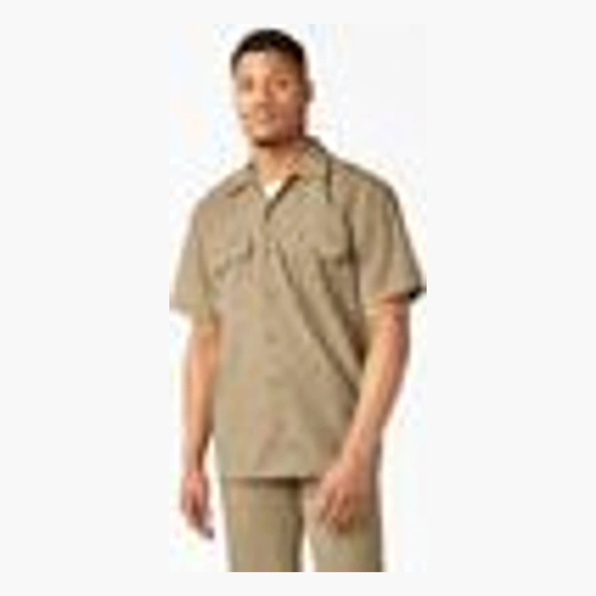 Person wearing Woven Twill Shirt S/S Woven Black S/S Woven, Man wearing tan twill shirt against neutral white background -