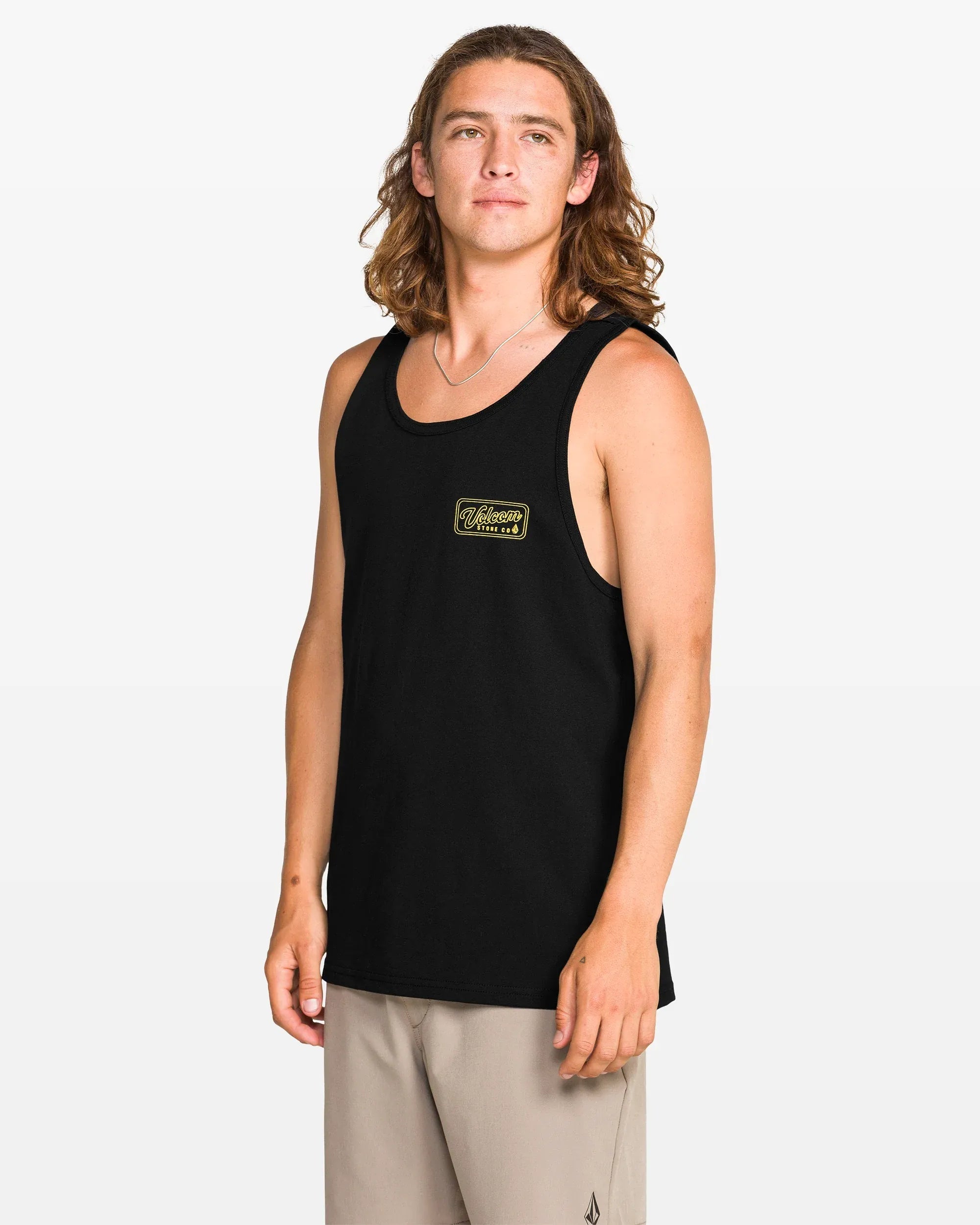 Person wearing Wrecking Tank Apparel Black Apparel, Man standing against white studio backdrop wearing black tank top with