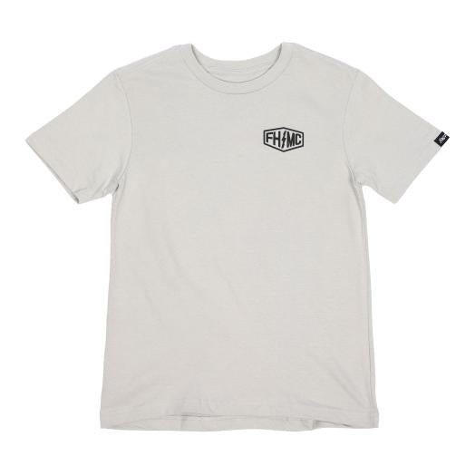 Close-up of Youth Gilmore Tee Kids Black Kids Tee showing Cream tee with small black hexagonal shield logo on chest and