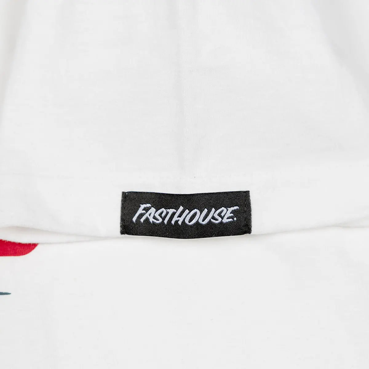 Care label on Youth Runner White Tee showing Black woven label with white italic script text - Slowride Supply