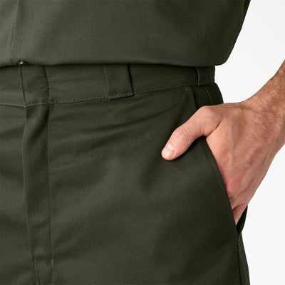 Person wearing 42283 13" Loose Fit Work Short Shorts Silver Shorts, Hand in front pocket of olive green work shorts against