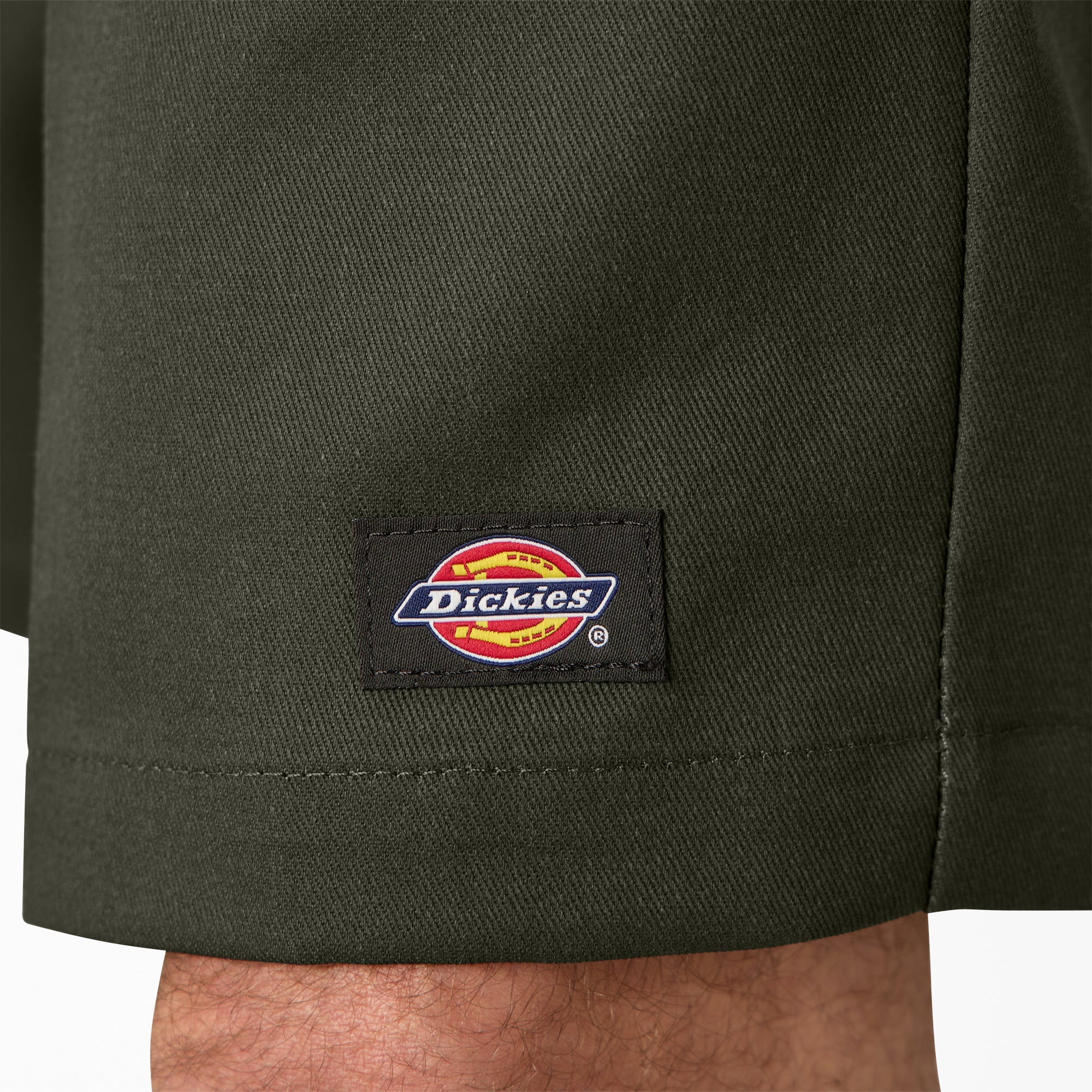 Close-up of 42283 13" Loose Fit Work Short Shorts Silver Shorts showing Woven brand label with red and yellow oval logo on