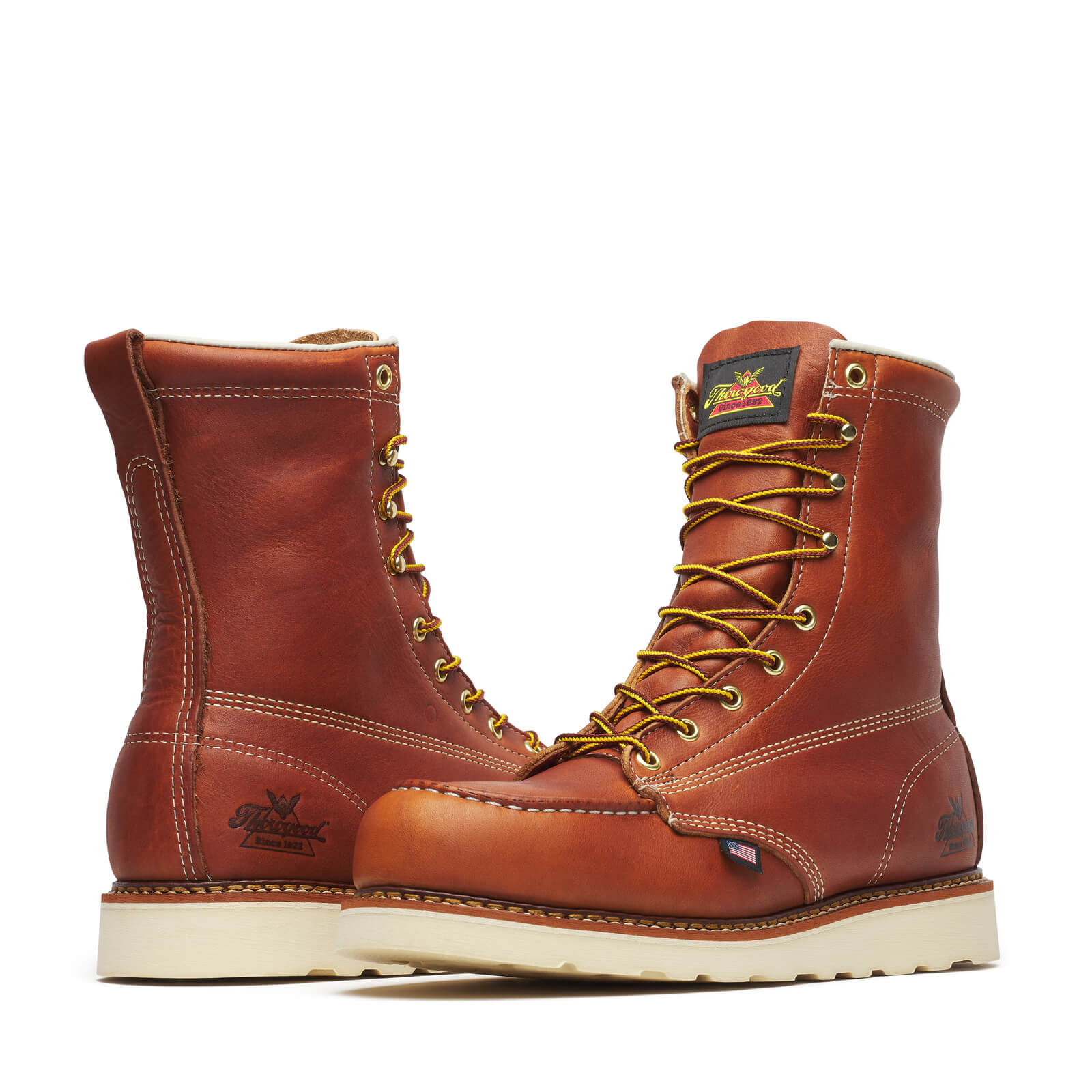Close-up of 804-4208 8" Boots Tobacco Boots showing Pair of reddish-brown leather work boots with cream sole, gold eyelets,