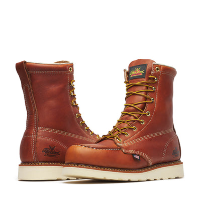 Close-up of 804-4208 8" Boots Tobacco Boots showing Pair of reddish-brown leather work boots with cream sole, gold eyelets,