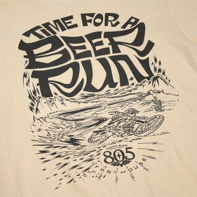 Close-up of 805 Desert Run Black Tee showing Black ink graphic on cream with desert landscape, bold lettering, and radiating
