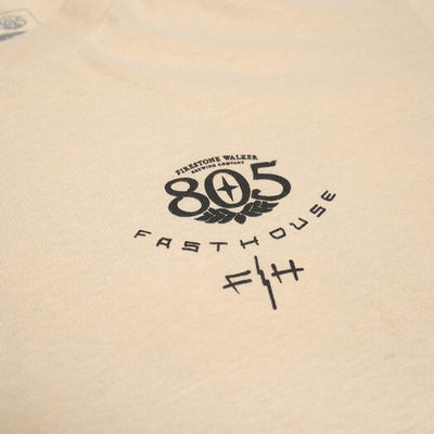 Close-up of 805 Desert Run Black Tee showing Black printed graphic with winged 805 logo and "Fasthouse" text on cream fabric