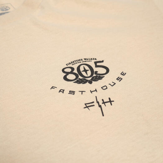 Close-up of 805 Desert Run Black Tee showing Black printed graphic with winged 805 logo and "Fasthouse" text on cream fabric