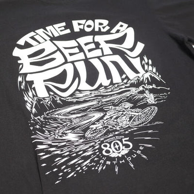 Close-up of 805 Desert Run Black Tee showing White ink print showing desert landscape with mountain, rocks, and radiating