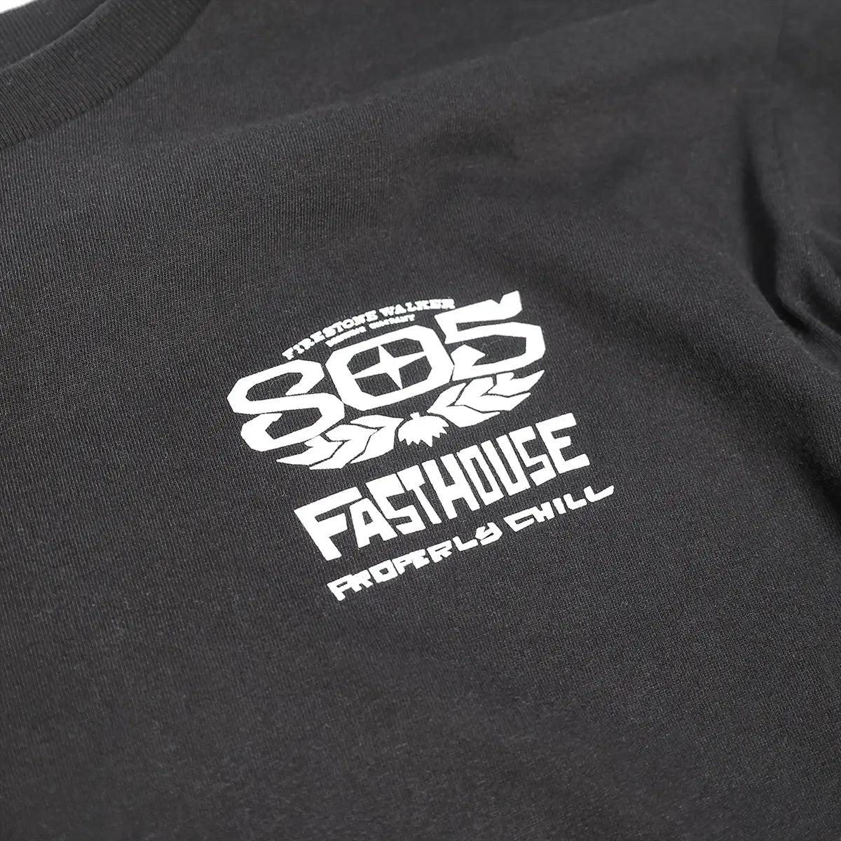 Close-up of 805 Gravel Black L/S Tee showing White printed graphic with hop cone and text reading "805 Fasthouse Roadrills