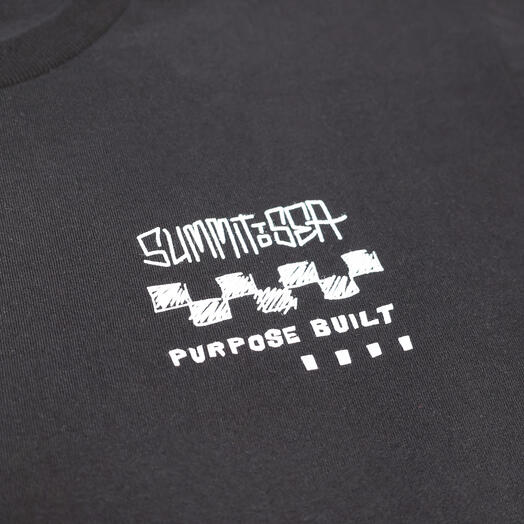 Close-up of 805 Purpose Black Tee showing White line-art logo with hatched checkbox graphic and "Purpose Built" text on