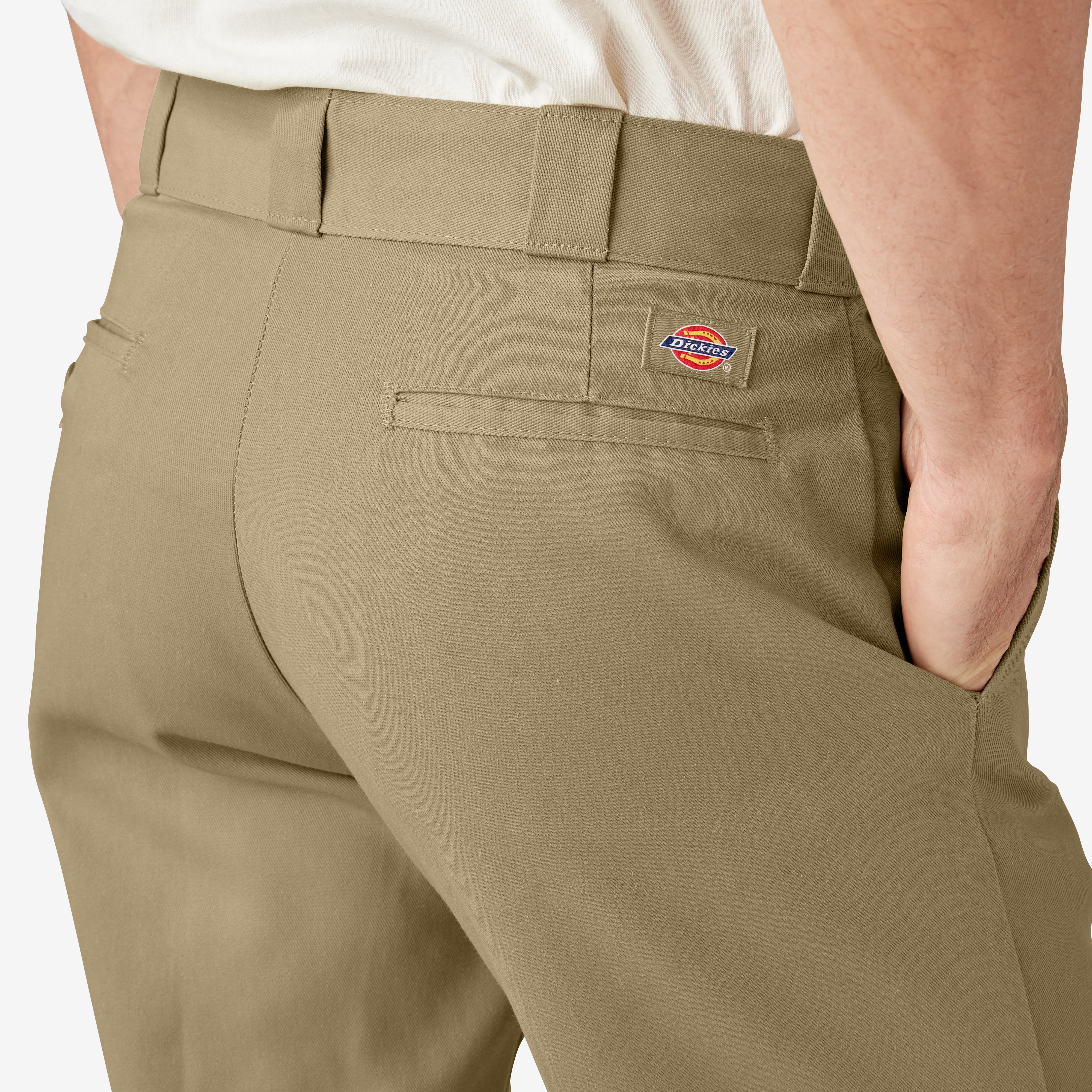 Person wearing 874 Original Work Pant Pants Black Pants, Khaki work pants worn casually with white shirt, studio setting